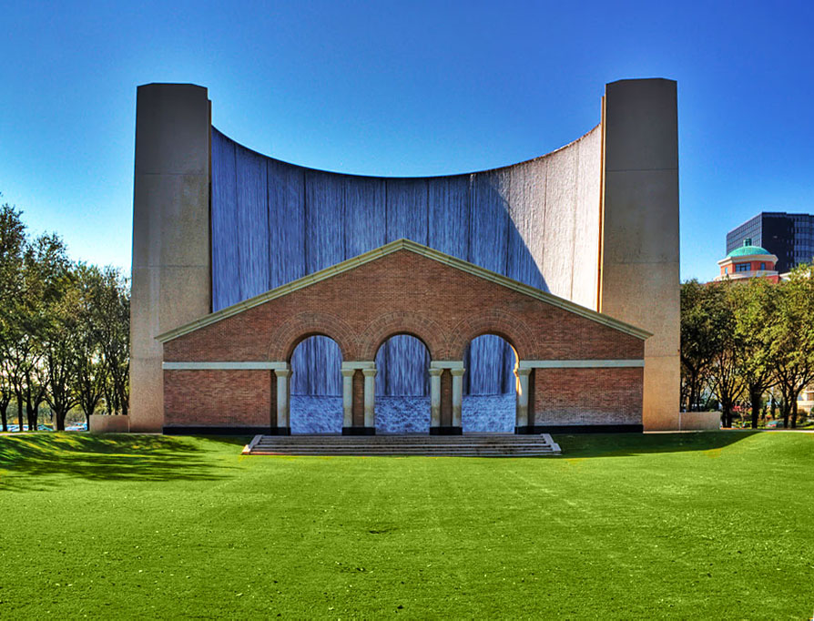 A standalone man-made waterfall framed by three centered arches known as the Williams Waterwall park in Uptown Houston, Texas.