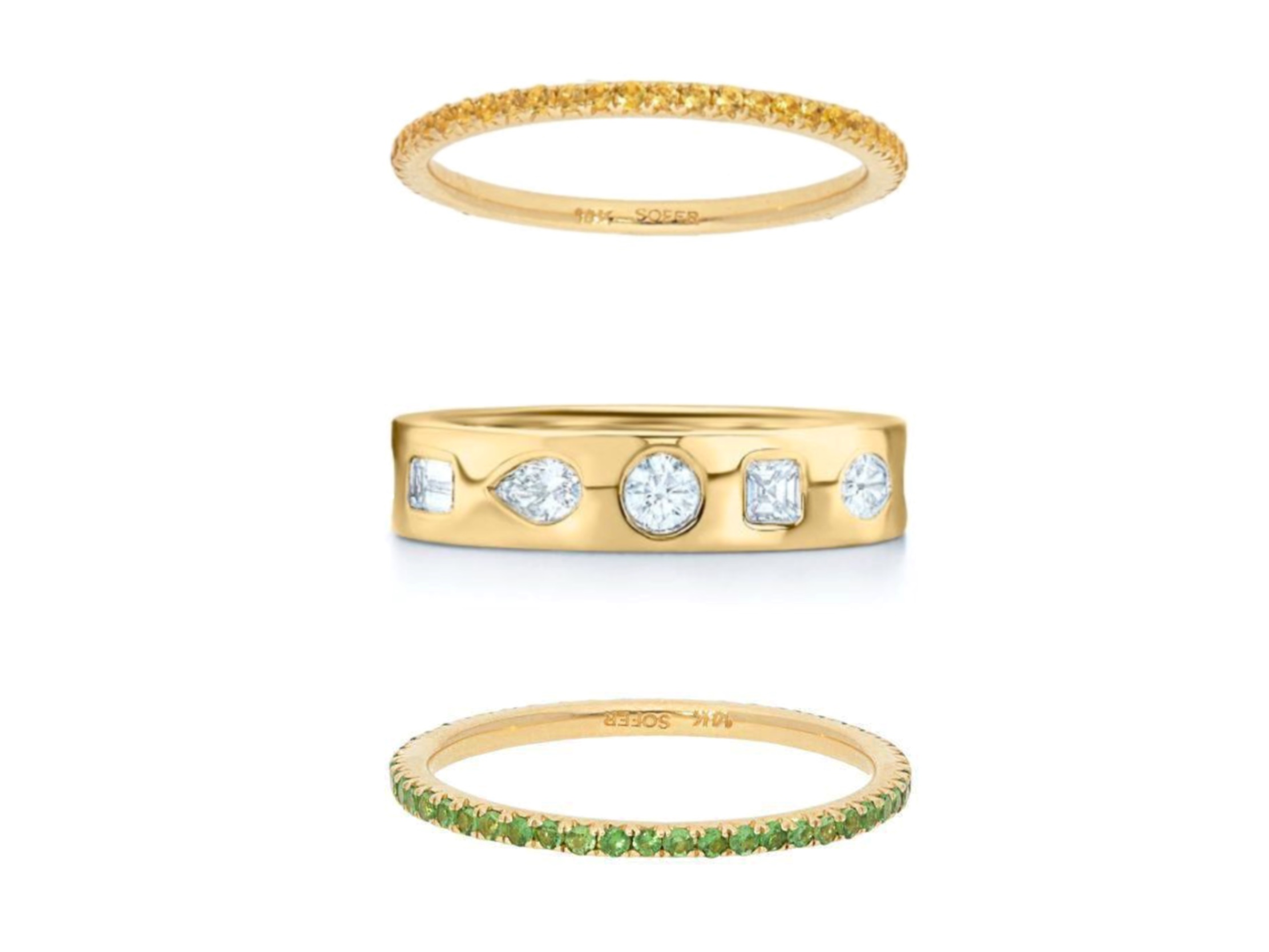 A stack of yellow gold rings with different gemstones. The bottom ring is a the  Tsavorite Pavé Eternity Stackable Band from Deutsch Signature, the center band is the Stackable Ring with Fancy Shape Diamonds by Kwiat and the top band is the Deutsch Signature Yellow Sapphire Eternity Band, all available at Deutsch Fine Jewelry in Houston, Texas.