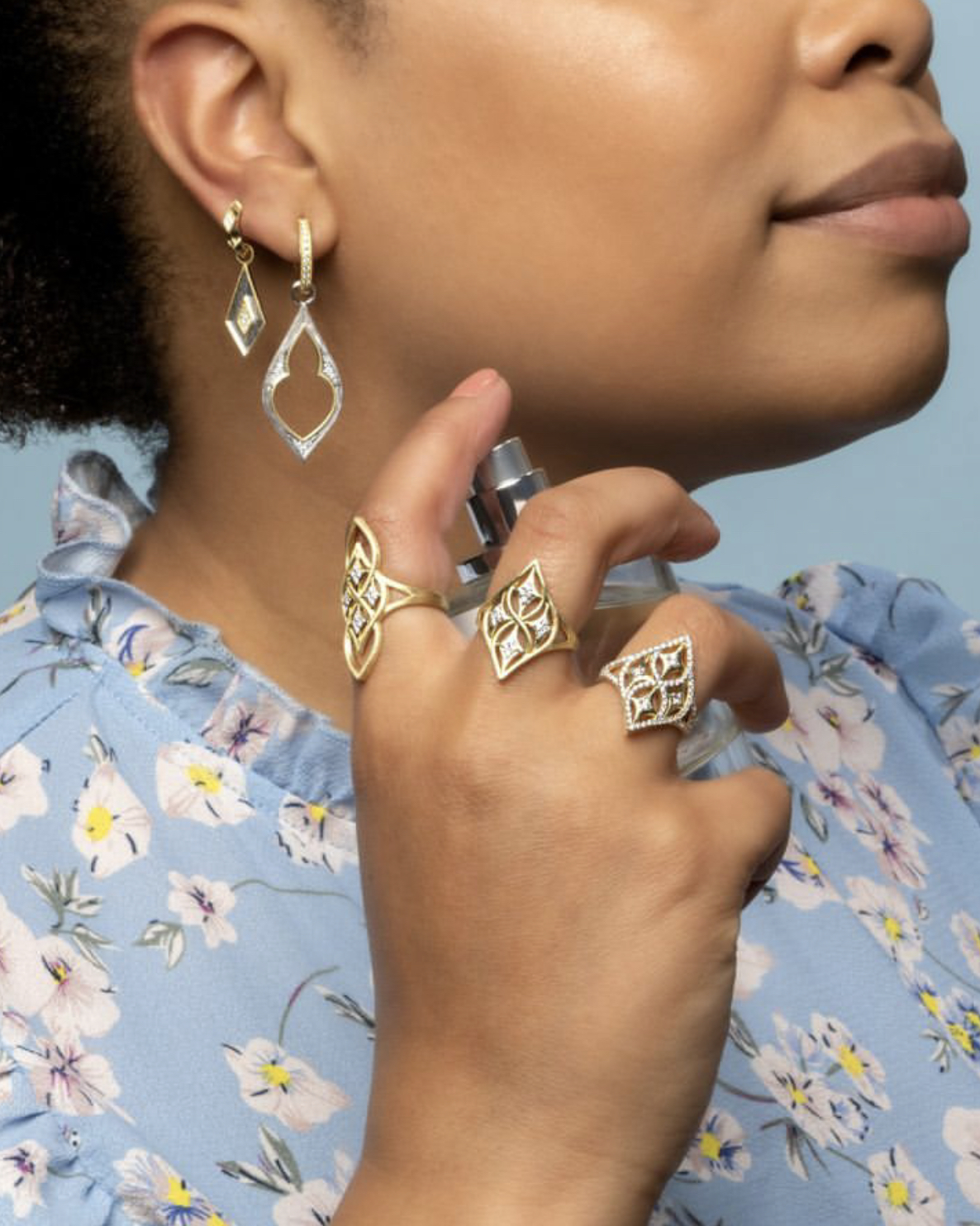 Woman spraying perfume in Jude Frances earrings -- Jude Frances designs available at Deutsch Fine Jewelry in Houston, Texas