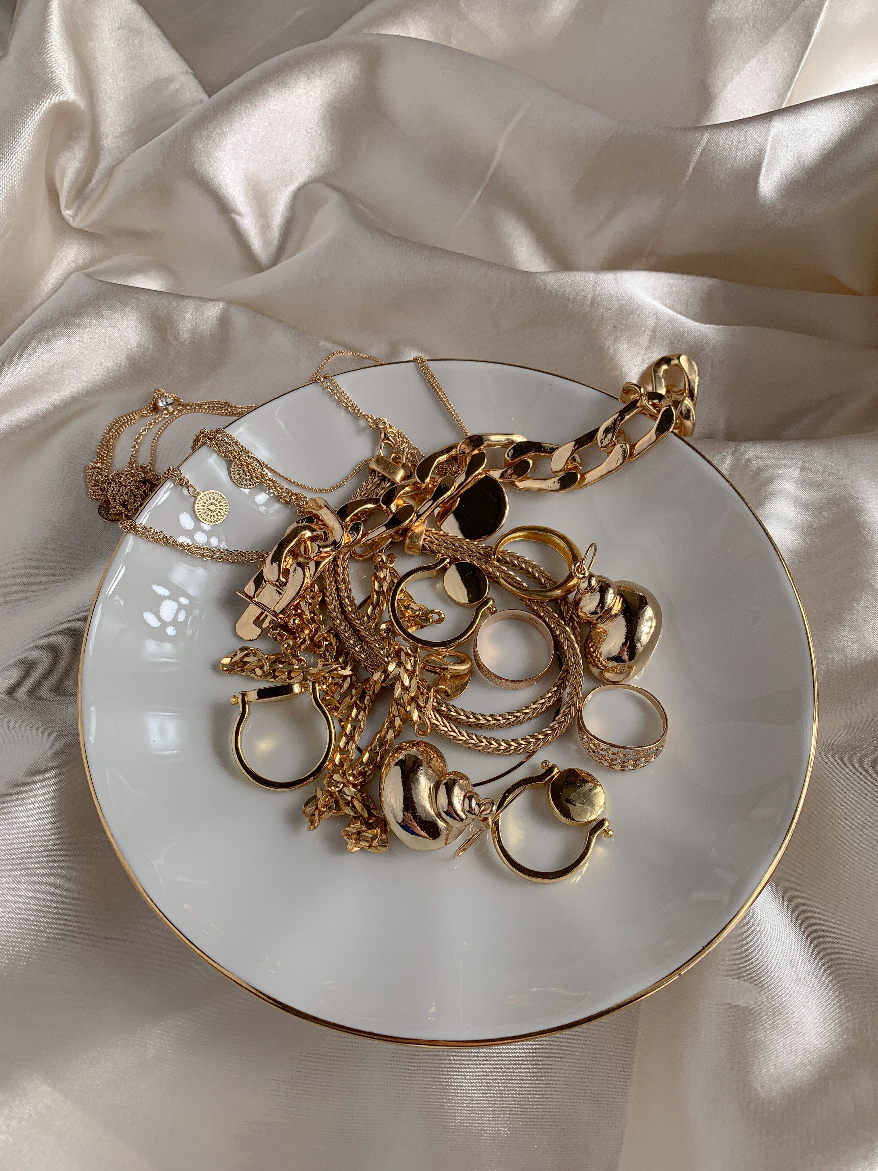 Golden jewelry in a white dish