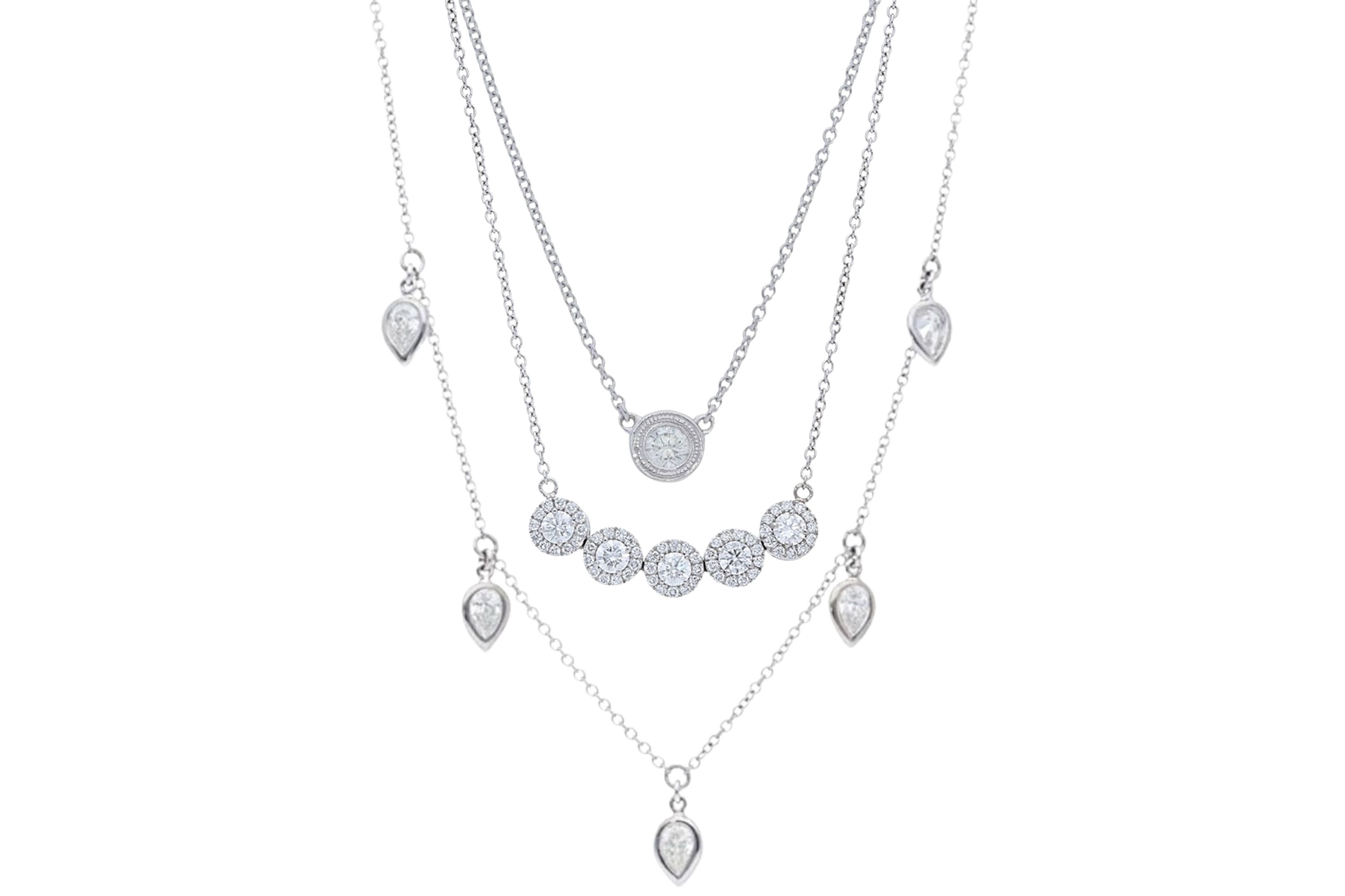 A #neckmess necklace stack made with the Single Milgrain Bezel Diamonds by the Yard Necklace, 5 Pear Diamond Bezel Dangles Necklace, and the 5 Halo Diamond Necklace by Deutsch Signature, available at Deutsch Fine Jewelry in Houston, Texas.
